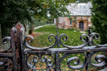 Old rusty iron gate to churchyard.