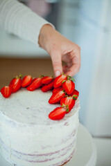 Young beautiful woman bakes a cake. Sweets. Confectionery.