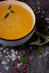 selective focus. Homemade Beef Bone Broth in a deep soup bowl. on a dark background. with the addition of spices-salt and pepper. Bones contain collagen, which provides the body with amino acids