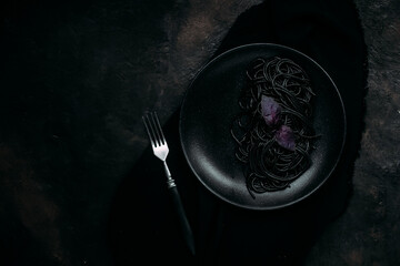 Black pasta in a black plate