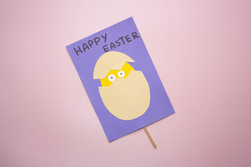 Naklejka premium Easter greeting card in egg shape. How to make children's paper craft. Step 13. Simple creative art project. Step by step instructions. Homemade easy paper applications. DIY concept. Final result