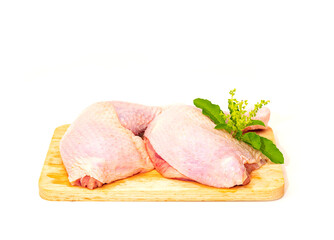 Fresh chicken legs ready to cook on a wooden cutting board.