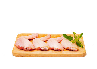 Fresh chicken wings ready to cook on a wooden cutting board.