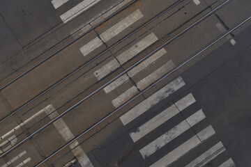Obraz premium Top view of the pedestrian crossing, road with tram tracks, street background
