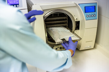 dental hygienist sterilizing clinical material