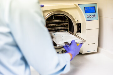 dental hygienist sterilizing clinical material