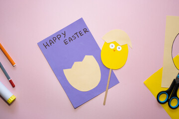 Naklejka premium Easter greeting card in egg shape. How to make children's paper craft. Step 12. Simple creative art project. Step by step instructions. Homemade easy paper applications. DIY concept.