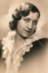 Germany - CIRCA 1920s: Portrait of female sitting at bench in studio Vintage Carte de Viste Art Deco era photo. Close up face