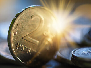 coins rubled in the rays of the sun background