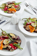 Grilled vegetables on a white plates. restaurant