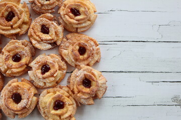 Carnival roses with jam and powdered sugar - traditional Polish cookies eaten during carnival and fat Thursday