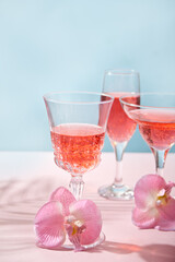 Summer tropical pink cocktail in a different glasses decorated pink orchid flowers