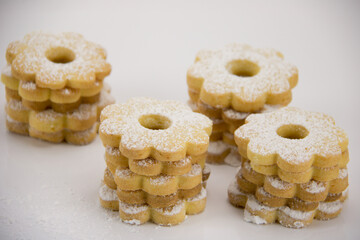 canestrelli biscuits covered with powdered sugar piled on white