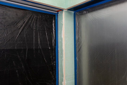 Installation for external roller shutters made of plasterboard inside the building, windows are covered with protective foil.