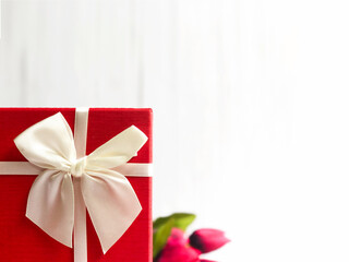 Big present with the red tulips on white background, celebration concept.