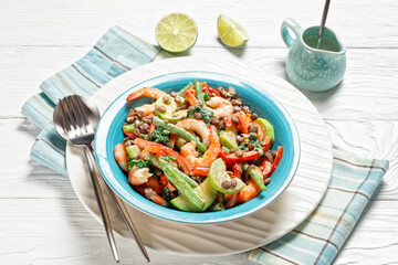 Salad of lentils, shrimps, wilted kale on a plate