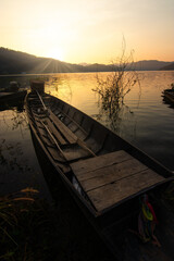 Rowing boat in a lake with sunset sky