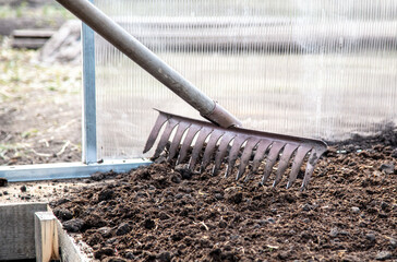 The rake is on the ground.