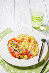 pasta with avocado, tomatoes and lime, top view