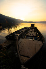 Rowing boat in a lake with sunset sky