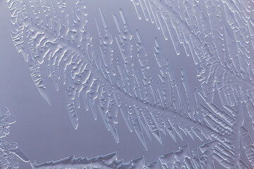Blue patterns from frost on glass as a background.