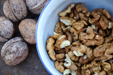 Walnuts harvest on vintage metal background. Walnut kernels from village garden. Organic autumn nuts harvest.