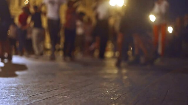 Slow motion of many couples dancing latino dances outside a lot of copy space on foreground