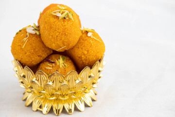 Motichur Laddu Also Called Motichoor Ladoo Decorated In Golden Dessert Bowl. Meetha Laddoo Is Served To God In Indian Festivals Like Holi Pooja Diwali Puja Eid Rakshabandhan Deepawali And Weddings