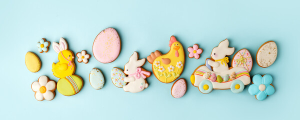 Set of Colorful easter cookies on blue background, assortment sweet gifts, seasonal springtime holiday greeting card, creative idea for decor, event menu, funny cute food, banner, flyer, invitation