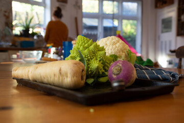 Vegetables on a table with person in the background