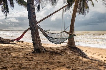 Africa beach with a hammock and a hanging swing in the background in the tropical part of Ghana Axim beach located in west africa