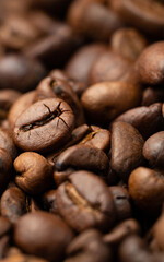 Roasted coffee beans background. Selective focus, macro, vertical orientation