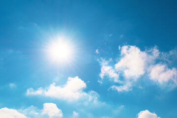 Naklejka na ściany i meble Bright blue sky and sun flare in spring sky with clouds vapor.