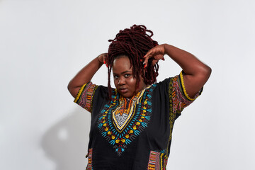 Plump haitian woman holding raised hands near head