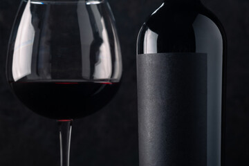 Red wine with a blank label, mockup logo on a black background