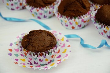 Chocolate cupcakes with alamonds, colorfull hearts onliners, blue ribbon, valentine cake