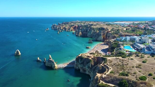 Aerial view flying over Praia Dona Ana and the Atlantic ocean coast. Lagos, Algarve, Portugal.