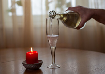 white sparkling wine poured from bottle to glass
