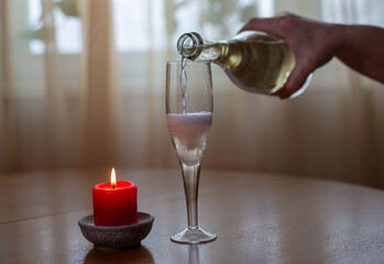 white sparkling wine poured from bottle to glass