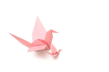 Two origami cranes isolated on white background.