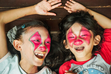 Fototapeta premium Portrait of cute Asian children with funny clown make-up on their face