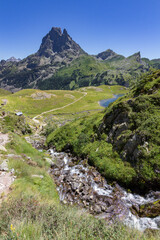 Obraz premium Waterfall in the lakes of Ayous near the Midi d'Ossau mountain in the Pyrenees (France)