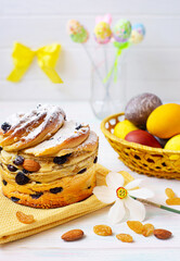 Baked Easter cakes with colored eggs. Decor, raisins, almonds, daffodil flower spring holiday