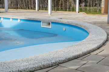 close up image of empty swimming pool without water in hotel, renovation process, preparing for new touristic season