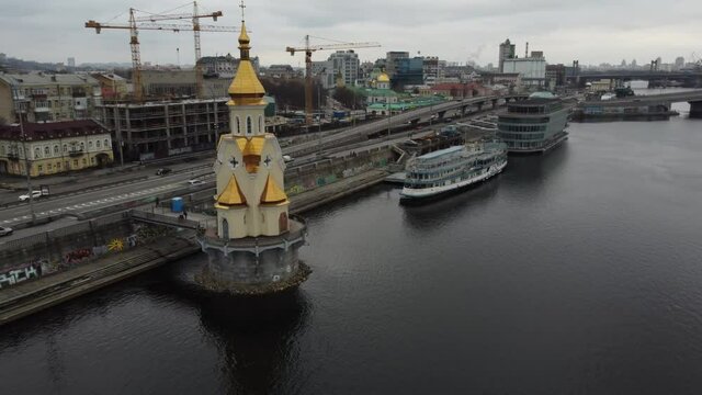 Fly over a beautiful little church on the river