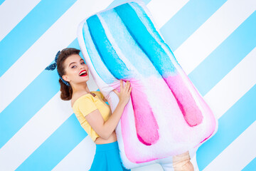 Sexy surprised woman with ice-cream in hands and open mouth. Colorful background in pop art retro comic style on striped blue background. Pinup and pop art concept