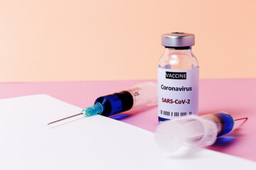 Transparent glass vials with test COVID-19 vaccine, with syringes