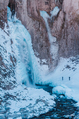 Fototapeta na wymiar Frozen waterfall in winter in the mountains. Mountains landscape photo. 