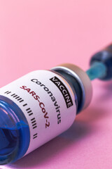 Transparent glass vials with test COVID-19 vaccine, with syringes