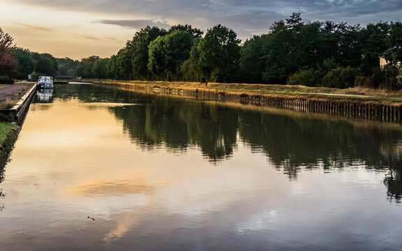 Sunset after a rainy day on the Loire Lateral Canal in Cuffy, in the Berry region of France